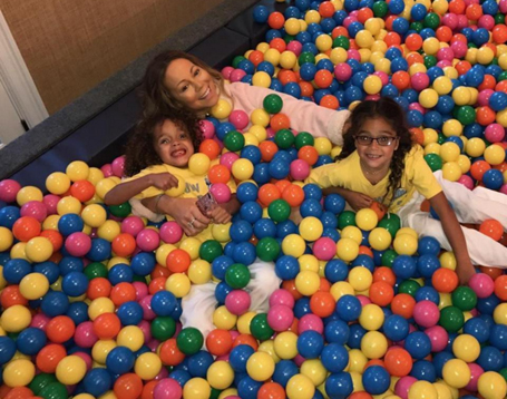 Mariah and twins have festive moments in the ball pit | mcarchives.com