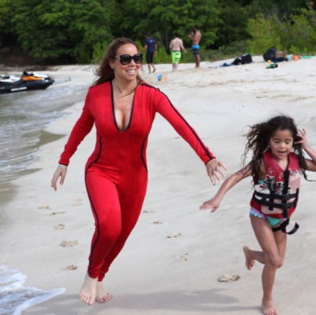 Mariah enjoys a beach day in plunging red one-piece | mcarchives.com