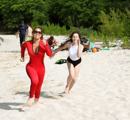 Mariah enjoys a beach day in plunging red one-piece | mcarchives.com