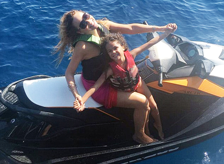 Mariah Carey poses on a jet ski with daughter Monroe | mcarchives.com